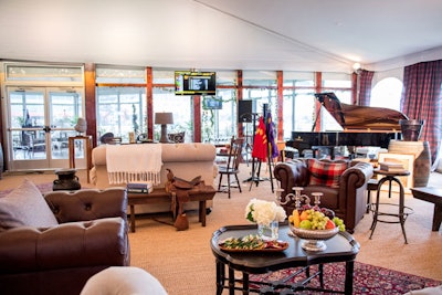 The interior of the tent had a country estate feel, with leather seating, a grand piano, and touches like throw pillows and blankets. Decor items directly referenced racing, including jockey silks and a saddle.