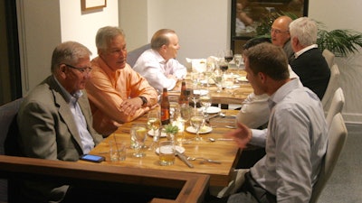 Enjoying themselves at a company dinner.