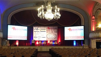 A 10.5-by-16-foot backdrop banner, brochures, a program book, attendee lists, directional posters, and voting flags