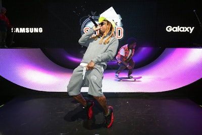 Lil Wayne performed a surprise show for fans at the Samsung exhibit to promote his mobile skateboarding game Sqvad Up. He performed parts of 15 songs.