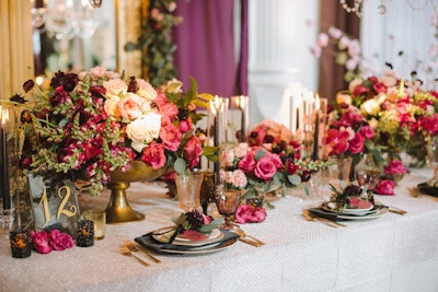 The table known as 'Alexandrine’s Romantic Spring Dream” was designed by Kelsey Events and Ixora Floral Studio. Black satin napkins, ornate china, and open roses created a look of sheer opulence.