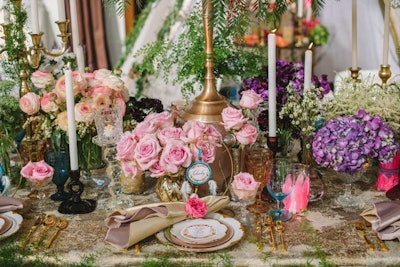At a table called “Boho Gypsy Princess,” designed by Bluebell Events and Mark’s Garden, clusters of flowers by type from Revelry Event Design filled vessels of varying kinds and heights.