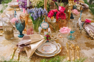 Gold stemware and gold-rimmed china added glamour to contrast with the whimsical vibe.