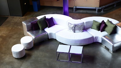 Clean white and silver metallic curved modular Mondrian furniture shown in a raw space.