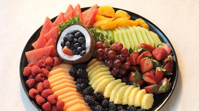 Fruit platter with seasonal fruits, melons, and berries,