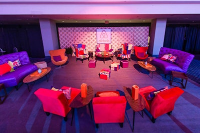 Airbnb captured the retro theme in its sponsored lounge with bright purple sofas, multi-fabric wingback chairs, and floral and patchwork pillows.