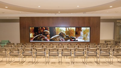 The pre-function room with a breakout and touch screen video wall.