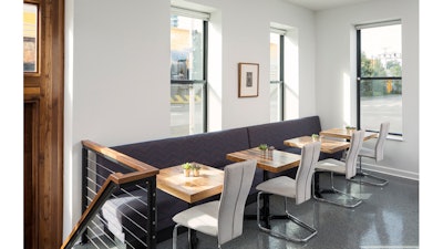 Banquette seating with sun-filled windows.