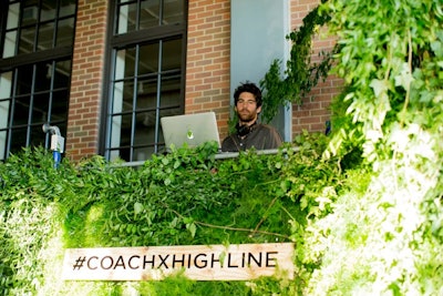 The event's two DJs were positioned on an elevated platform inside the High Line passageway on scaffolding shrouded by greens ranging from asparagus fern and bear grass to wisteria and spring rye.