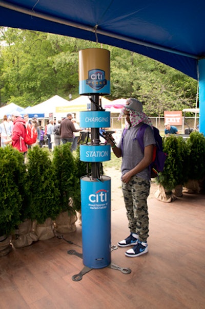 At Citi's tent, which was located in the Market area of the festival, guests were invited to create custom videos about Harlem cuisine to share on social media. The tent also featured a culinary map of Harlem, lunch tote giveaways, and a charging station, along with an outdoor lounge area with seating and branded umbrellas.