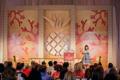 Wedding planner Mindy Weiss spoke at the three-day conference. The custom-designed speaker stage backdrop by Event Effects Group featured the event's beachy color palette and icons that were designed by Gifts for the Good Life.