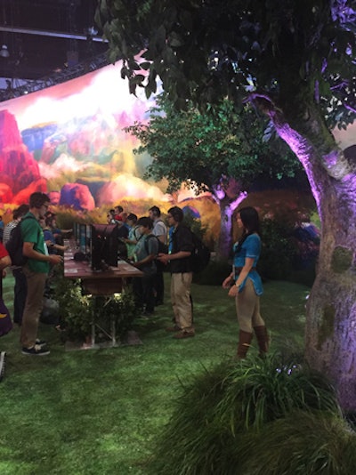 In Nintendo's exhibit, a green grass-like floor sprawled underfoot, and trees and foliage decorated the area, including under gaming stations, for a lush outdoor look.