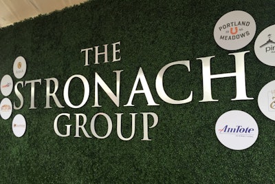 An arrivals wall featured hedging and signs featuring its racing and gaming properties.