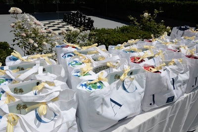 Gift bags tied with yellow and white striped ribbon included a rolled beach towel for use during the event's water activities.
