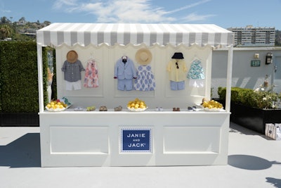 At the Janie and Jack event, families were welcome to pick up wardrobe pieces for their kids from a pop-up shop topped with a striped awning and decked with bowls of lemons. The wooden structure had prim details such as moulding trim and integrated signage.