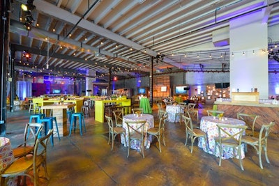 The wall arrangement for the auction items opened up 100 square feet of event space that Design Foundry filled with high-boy and café table seating.