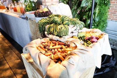 Settings at the two central bars included raw vegetables featuring asparagus, radishes, sugar snaps, and long beans. Other settings featuring farmstand fruits and bakery baskets.