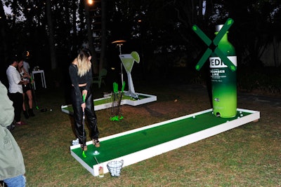 An oversize Svedka bottle decor piece backed a mini golf activity.