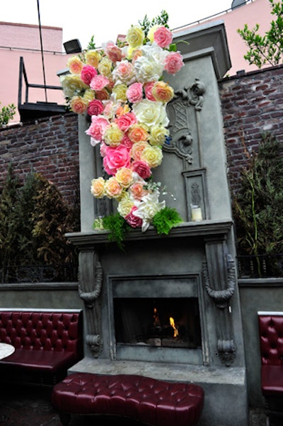 Oversized faux flowers in pink, yellow, and white decorated of the venue's two outdoor fireplaces in an unusual arrangement that seemed to defy gravity.