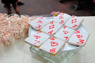 Nibbles from Modern Art Catering included on-theme sweets and savories. For dessert, there were sugar cookies in the form of playing cards, chocolate mousse teacups, pink and purple popcorn, and mini chocolate cupcakes with red rose-shaped frosted tops.