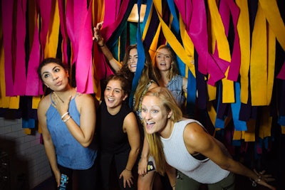 Guests could pose in an interactive photo booth that was decorated to resemble car-wash cloth strips.
