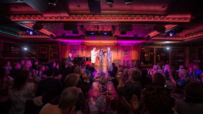 A wedding ceremony on stage in front of friends and family