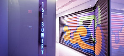 The lobby features the building's original security gate painted by Ben Eine.