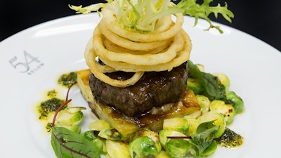 Grilled Creekstone filet mignon with potato gratin, sautéed Brussels sprouts, and crispy onions