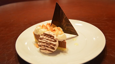 Coconut chocolate pie with chocolate pot de crème, coconut mousse, and baked coconut meringue