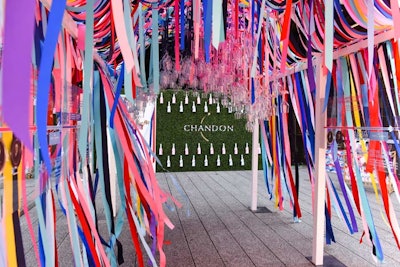 The event's most striking design element was an archway at the entrance created with colorful ribbons. 'Glasses hung from the colorful ribbons that represented the Chandon American Summer bottle design and the ties that bind this American brand to its French roots,' says Chandon's Christine Guzman. 'A symbolic timeline was displayed through the passageway, representing key moments in Chandon’s French-American history.'