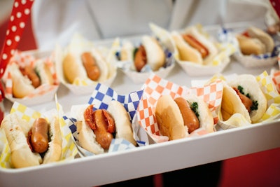 At the Lyric Opera of Chicago's 'Carousel Celebration' in April 2015, passed appetizers from Calihan Catering included miniature beef hot dogs with roasted tomatoes and oregano salsa verde—a twist on the American favorite.