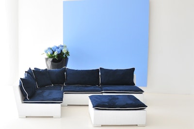 Taylor Creative’s Avalon collection features white all-weather rattan modular pieces with navy cushions and white piping. Prices range from $175 to $225 per piece; it's available for rent in New York.