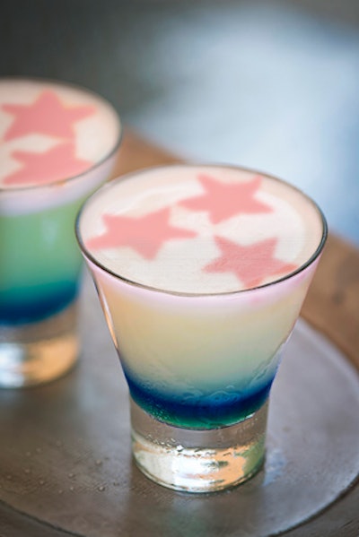 Rhumbar in Las Vegas serves Americana cocktails including the Patriot, which is made with vodka, lemon juice, simple syrup, blue Curaçao, and egg whites. The garnish is stars made of Angostura bitters.