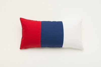Taylor Creative’s tri-stripe pillow ($30 each) is an easy way to add American flair to a seating area; it's available for rent in New York.