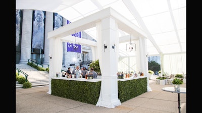 Custom outdoor bar structure featuring boxwood floral bars at The Field Museum.