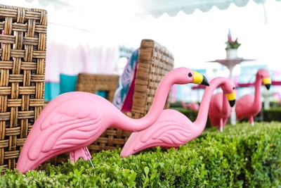 Plastic flamingos decorated hedging within the space.