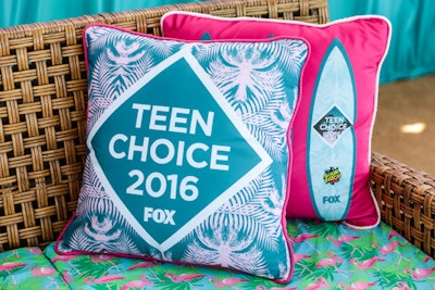 Boldly printed graphic throw pillows bore the name of the event and its host.