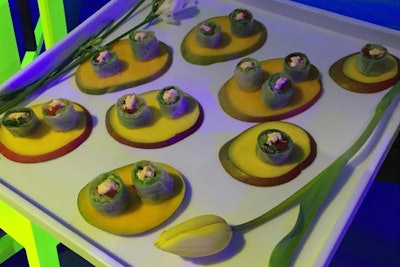 Single floral stems framed hors d’oeuvres like mango Thai basil summer rolls from Union Square Events at the Robin Hood Foundation gala in New York in May.