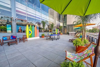 Design Foundry drew inspiration from the Copacabana Beach in Rio for the second-floor terrace of the museum. Beach chairs, umbrellas, and surfboards decorated the space.