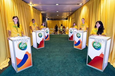 Yellow drapes lined the entryway to the party, and staffers put gold medals around the necks of attendees as they passed through.