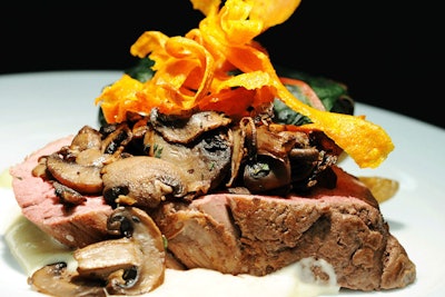 Carrot-chip ribbons are a popular and easy-to-make garnish, as seen here atop a roast tenderloin of beef with horseradish cream and brandied mushrooms.