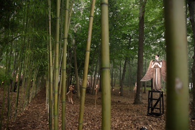 As guests entered into the Watermill Center's bamboo forest of live art installations, they were first greeted by Jacques Reynaud's 'Angels of Apocalypse.' Reynaud, a longtime Wilson collaborator, depicted six men as bronze statues clad in glittering bronze tunics and oversize wings; they sat atop high, hidden seats and brandished swords.