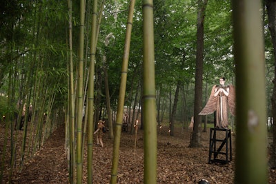 As guests entered into the Watermill Center's bamboo forest of live art installations, they were first greeted by Jacques Reynaud's 'Angels of Apocalypse.' Reynaud, a longtime Wilson collaborator, depicted six men as bronze statues clad in glittering bronze tunics and oversize wings; they sat atop high, hidden seats and brandished swords.