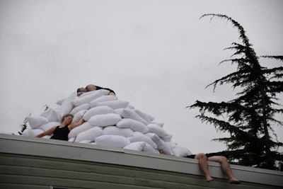 Brian O'Mahoney's 'Cats Sleep Anywhere' installation represents the artist's fourth time returning to the benefit. It showcased three performers climbing up and through a mountain of pillows atop one of the property's original south-facing sheds.