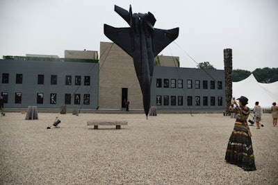 Located on the graveled west terrace was the Bruce High Quality Foundation's towering, 35-foot inflatable MIG fighter jet. The installation, called 'A Smack and Then Nothing,' as meant to project a sense of breathing despite being nose down, frozen in a point of contact into the earth. Surrounding the inflatable were performers on six high-backed platforms.