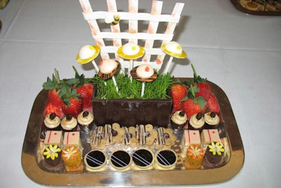 For a luncheon with a “hat party” theme, New York caterer Abigail Kirsch created a playful arrangement of desserts, including a white chocolate 'fence,' citrus macaron 'hat pops,' peanut-butter-and-jelly tarts, miniature carrot cake, and Devil's Food cakes topped with flowers.