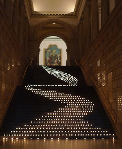 Event designer David Beahm used votive candles in a snaking pattern down the the Metropolitan Museum of Art’s stairs for a private corporate event.