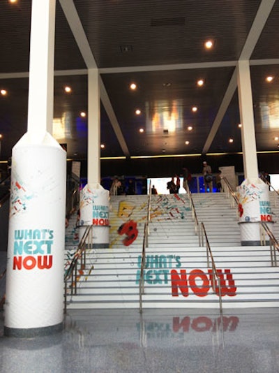 Each year, E3 takes over multiple halls in the Los Angeles Convention Center, as well as its lobby areas and on the plazas outside. The show and its vendors take over stairs for marketing and branding, as in this example from 2013, which used both the stairs and surrounding columns.