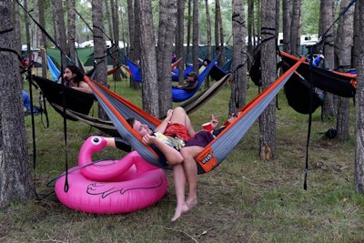 Attendees lounged in hammocks lined up in the trees along Bee Vee Beach Club during the daytime DJ sets.