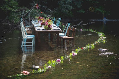 Bethlehem, Pennsylvania-based Allium Floral Design created a floral installation with local flowers, which trailed into the creek. The company also created a tablescape with florals, moss, and other natural elements.